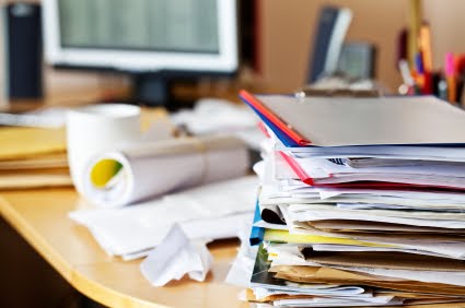 papers and files stacked on desk