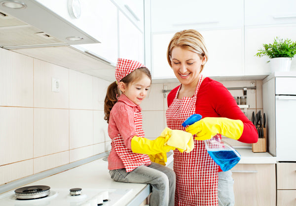 Mother and daughter cleaning in the kitchen