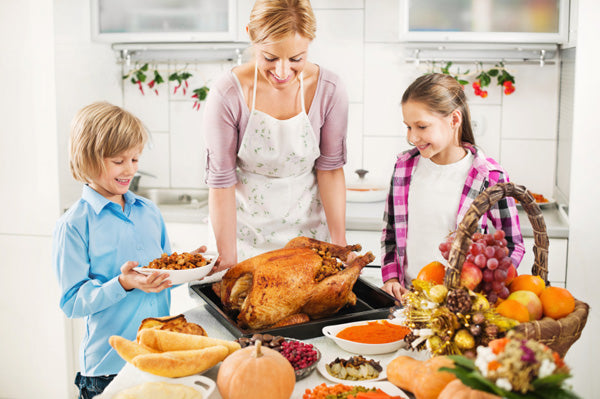 mother preparing food with children