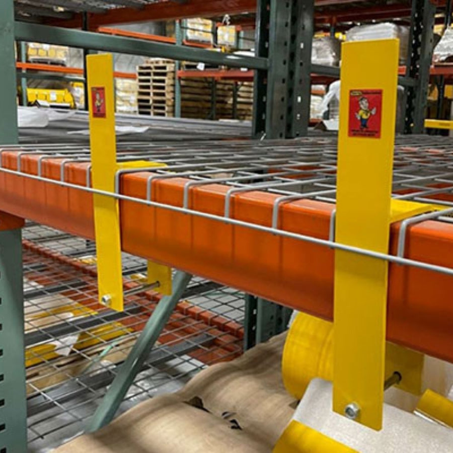 Warehouse shelving unit with orange and yellow safety barriers